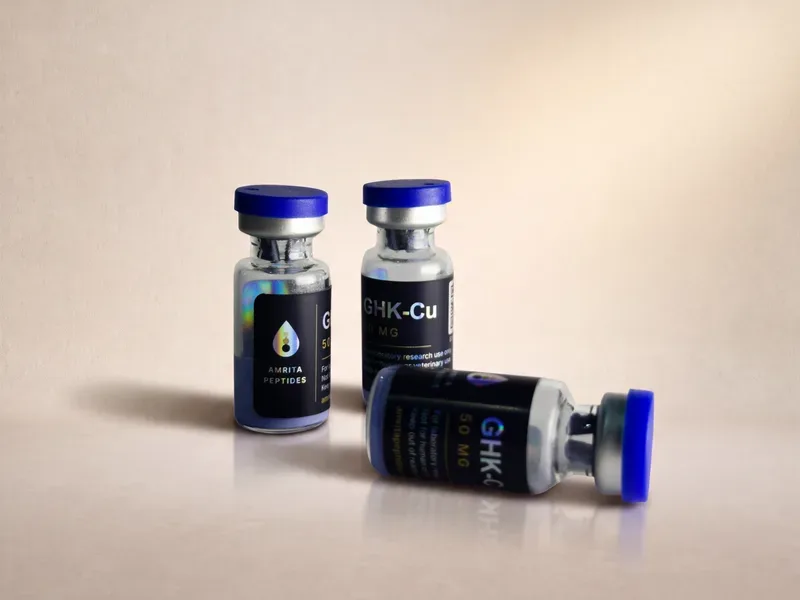 Amrita Peptides labeled GHK-Cu 50 mg vials, two upright and one lying on its side with the front label in view