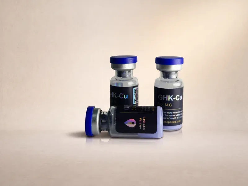 Amrita Peptides labeled GHK-Cu 50 mg vials, one lying on its side showing the drop logo panel