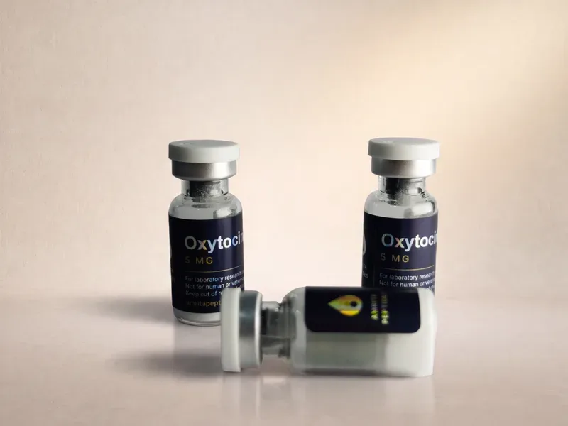 Amrita Peptides labeled Oxytocin 5 mg vials, two upright and one lying on its side showing the drop logo
